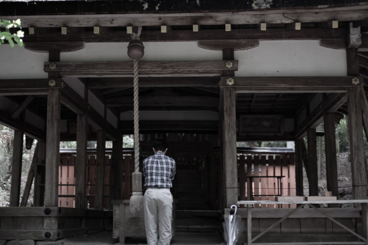 Person praying at Ota Shrine in Kyoto.