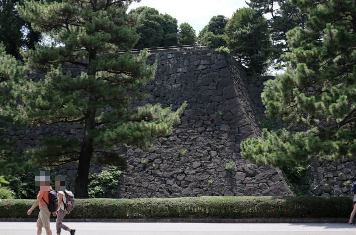 The stone walls of the old Edo Castle's Honmaru seen from near the Shiratori-bori moat.