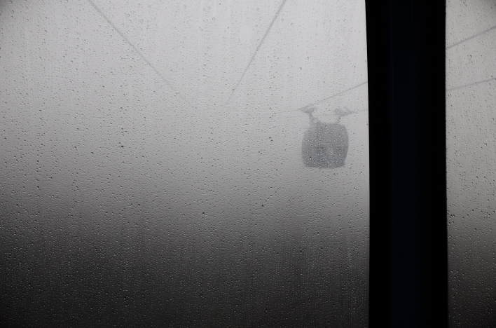 The Hakone Ropeway passenger car passes another cabin coming from the opposite direction.